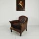 Antique leather club chair with stud detailing