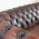 Classic cowhide Chesterfield sofa in English style with red/brown colours