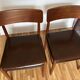 Two leather and Scandinavian teak chairs.