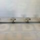 Chromed metal coat rack with four hooks