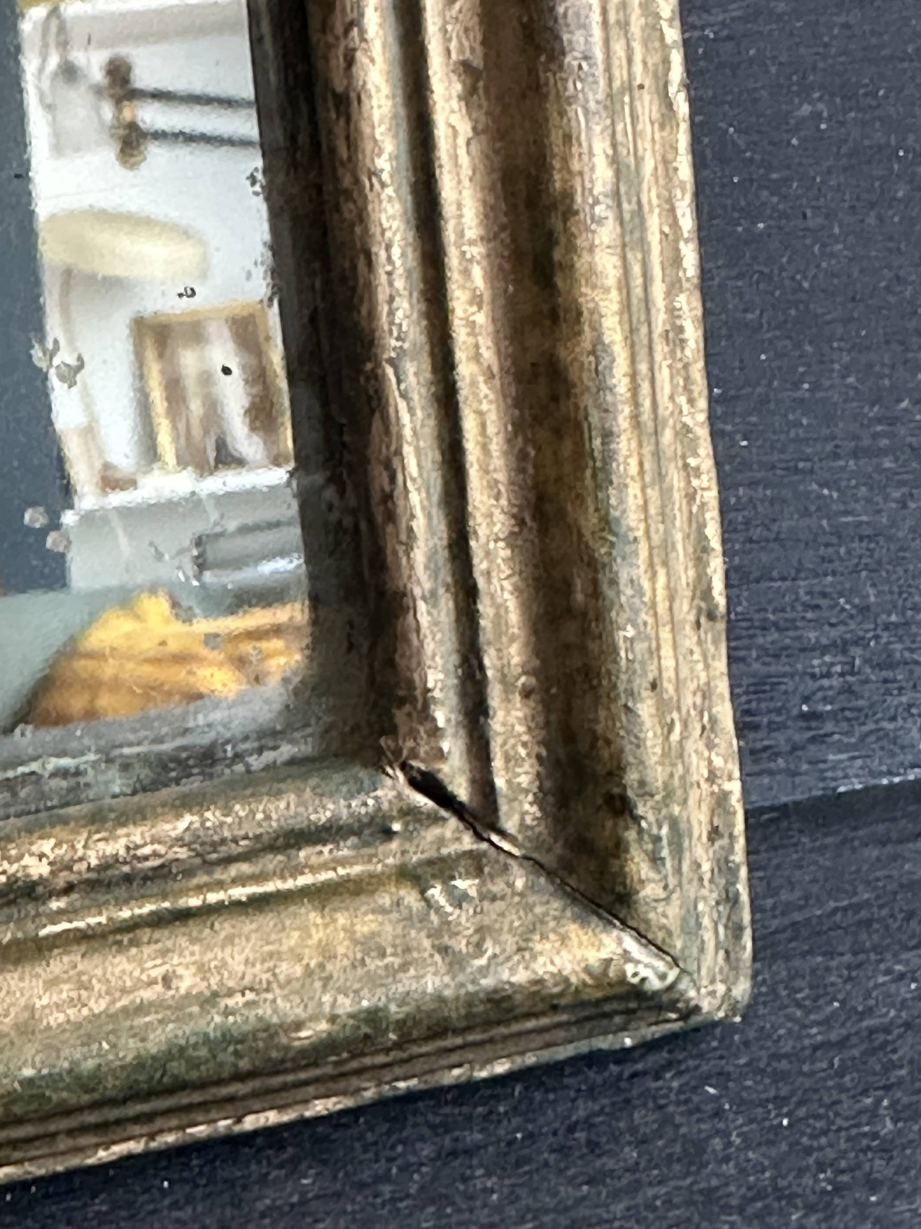 Miniature mirror from the 18th century in gilded wood, mercury glass.