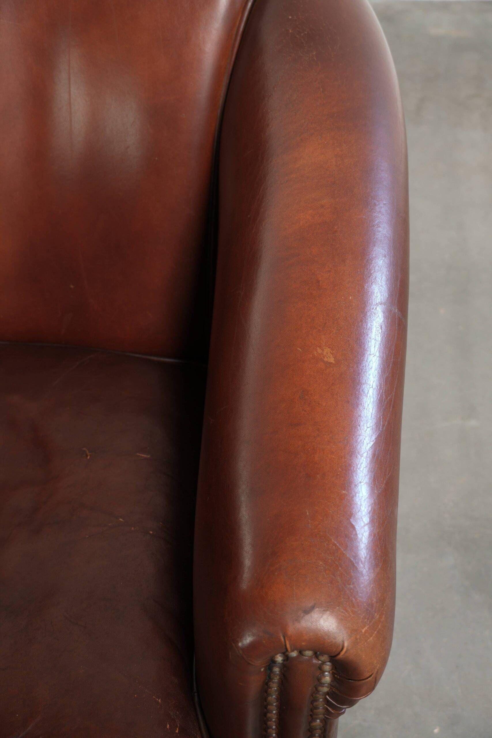 Set of 2 sheepskin club armchairs in a dark cognac colour