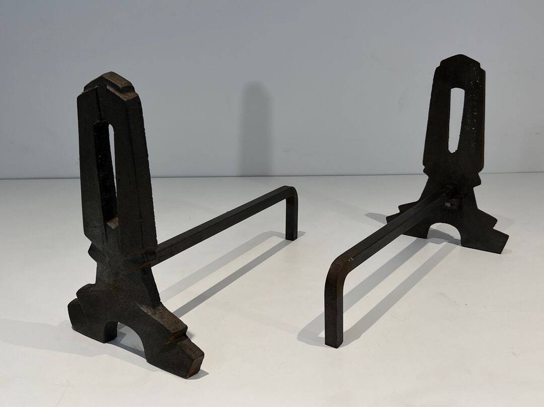 Pair of Modernist Andirons in Cast Iron with Openwork Uprights and Tripod Bases
