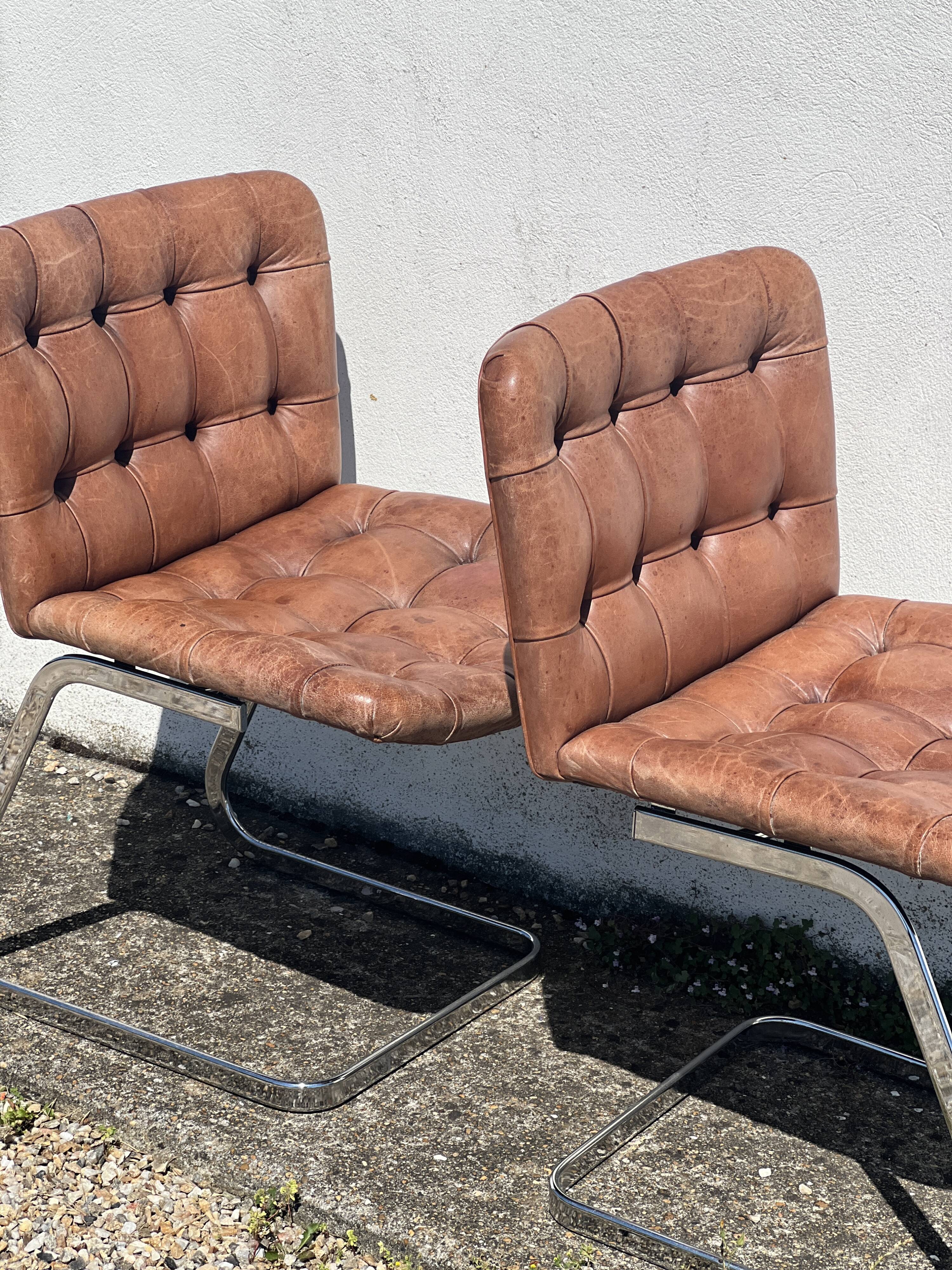 Pair of leather chairs by Robert Haussman