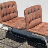 Pair of leather chairs by Robert Haussman