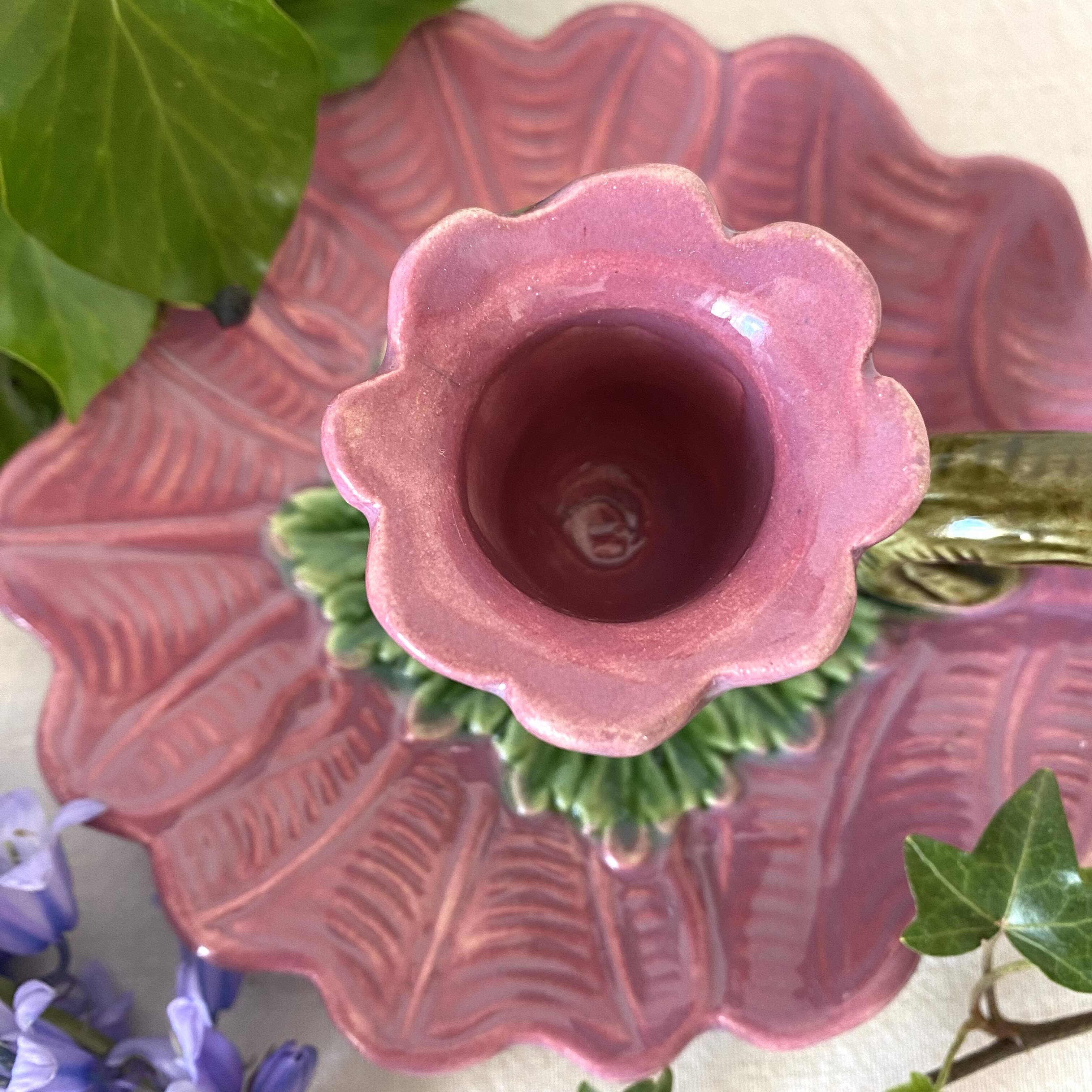 Antique slip candlestick depicting a flower