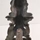 Pair of bronze andirons with black patina, 19th century, female caryatids