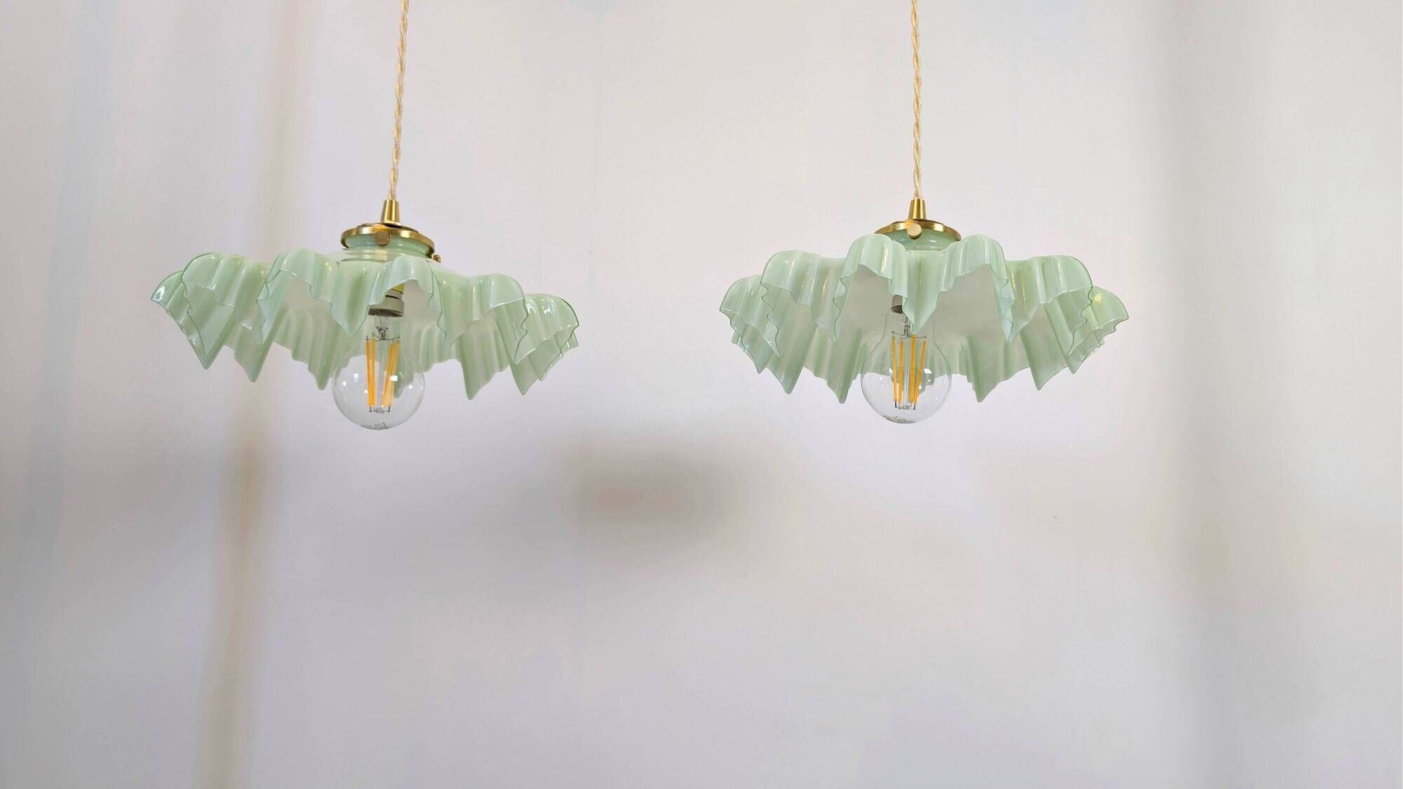 Pair of green opaline glass pendant lights – frosted poetry & Art Deco brilliance