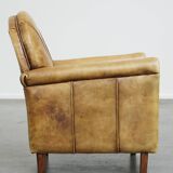Unique children’s armchair made of cowhide leather in Art Deco style, featuring a light cognac color