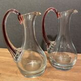 pair of crystal buires, handles with red tinted net decoration in the mass