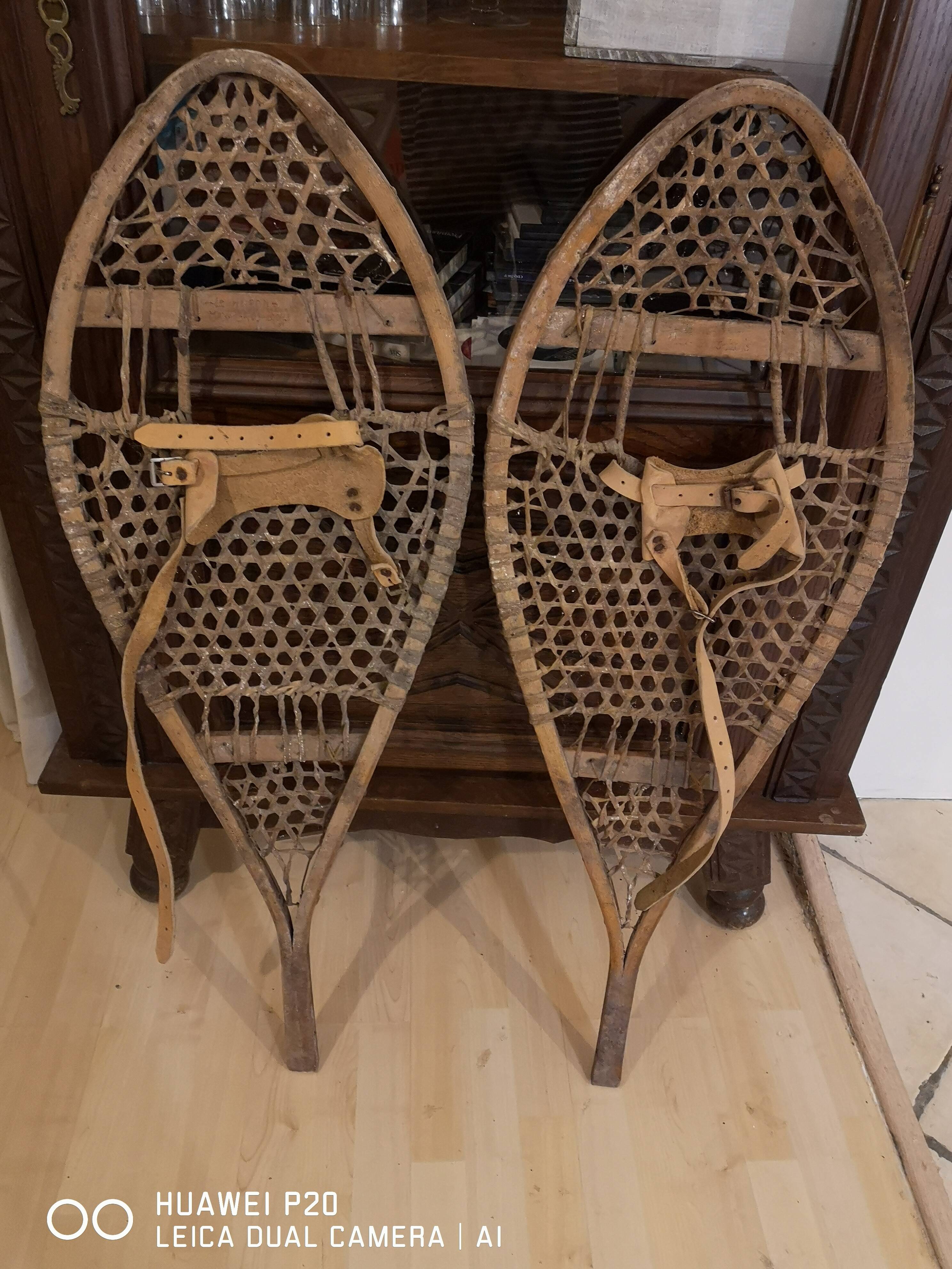 Pair of old snowshoes in wood, leather, and natural gut string