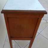 Antique bedside table with its marble top and white earthenware interior