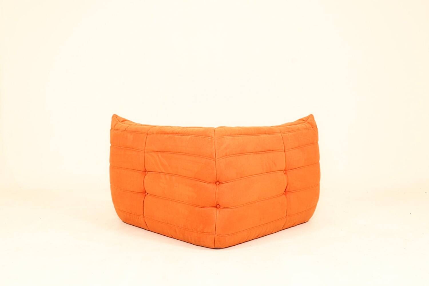 Togo sofa set and armchairs in pumpkin orange, 3 pieces, no label.