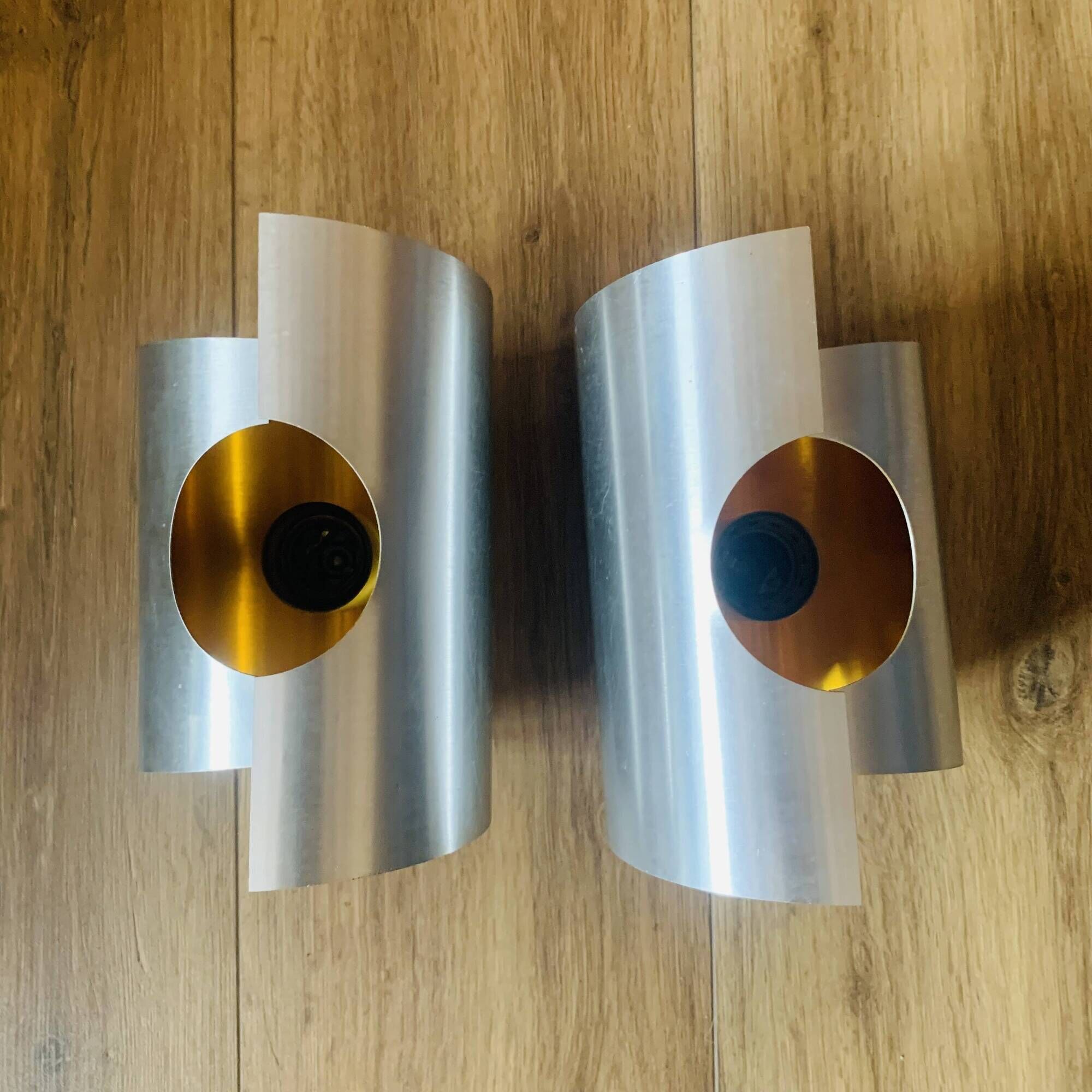 Pair of Space Age wall lights in brushed metal with a copper-orange interior.