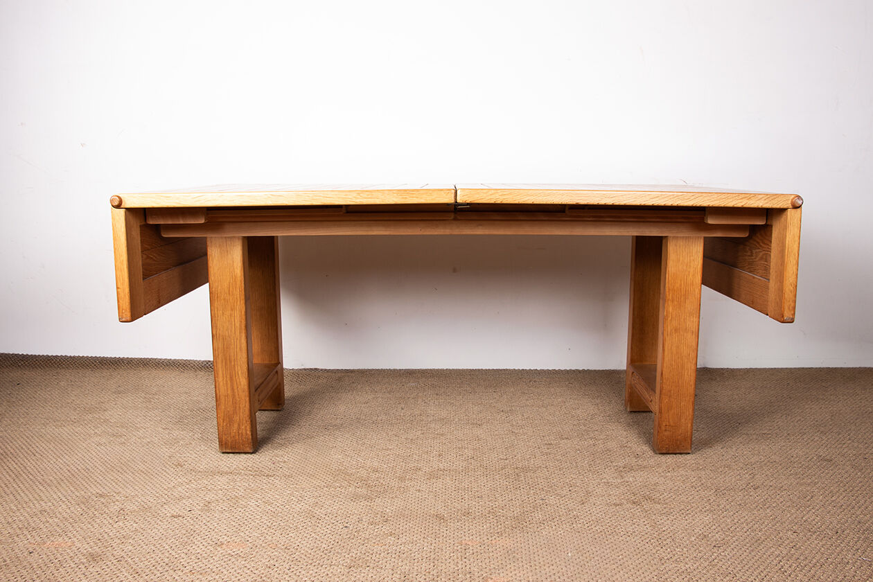 Large extendable dining table in solid oak by Guillerme and Chambron.