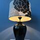 Small Space Age table lamp with a porcelain base and black and white flower shade.