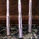 Five silver-plated metal appetizer forks with bamboo-style handles
