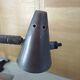 Old desk lamp with a small copper shade and a porcelain base.