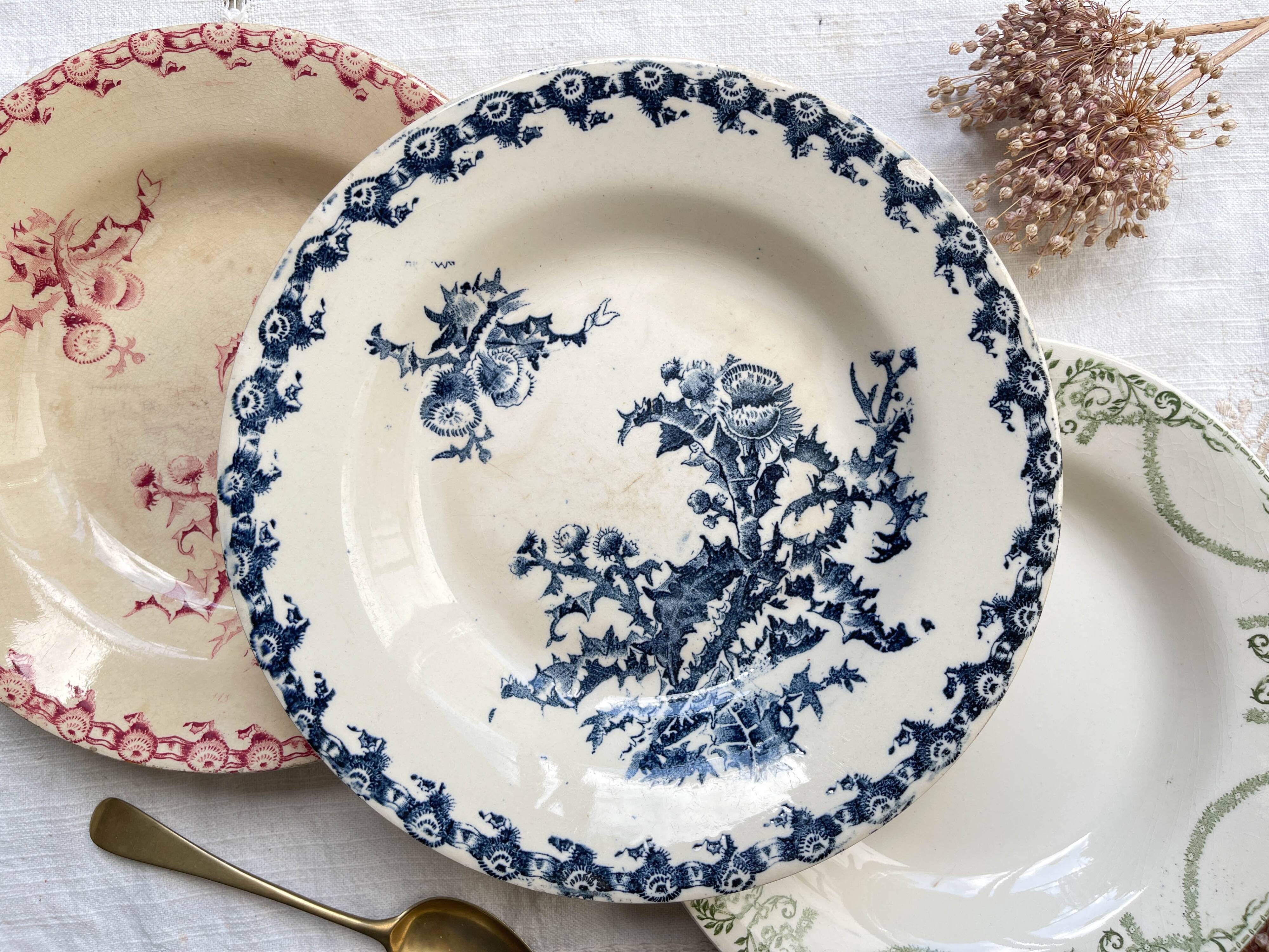 10 mismatched vintage soup plates in blue, green, and red ironstone