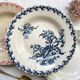 10 mismatched vintage soup plates in blue, green, and red ironstone
