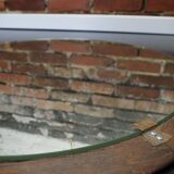 Round mirror in a vintage teak wood frame