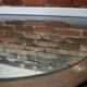 Round mirror in a vintage teak wood frame