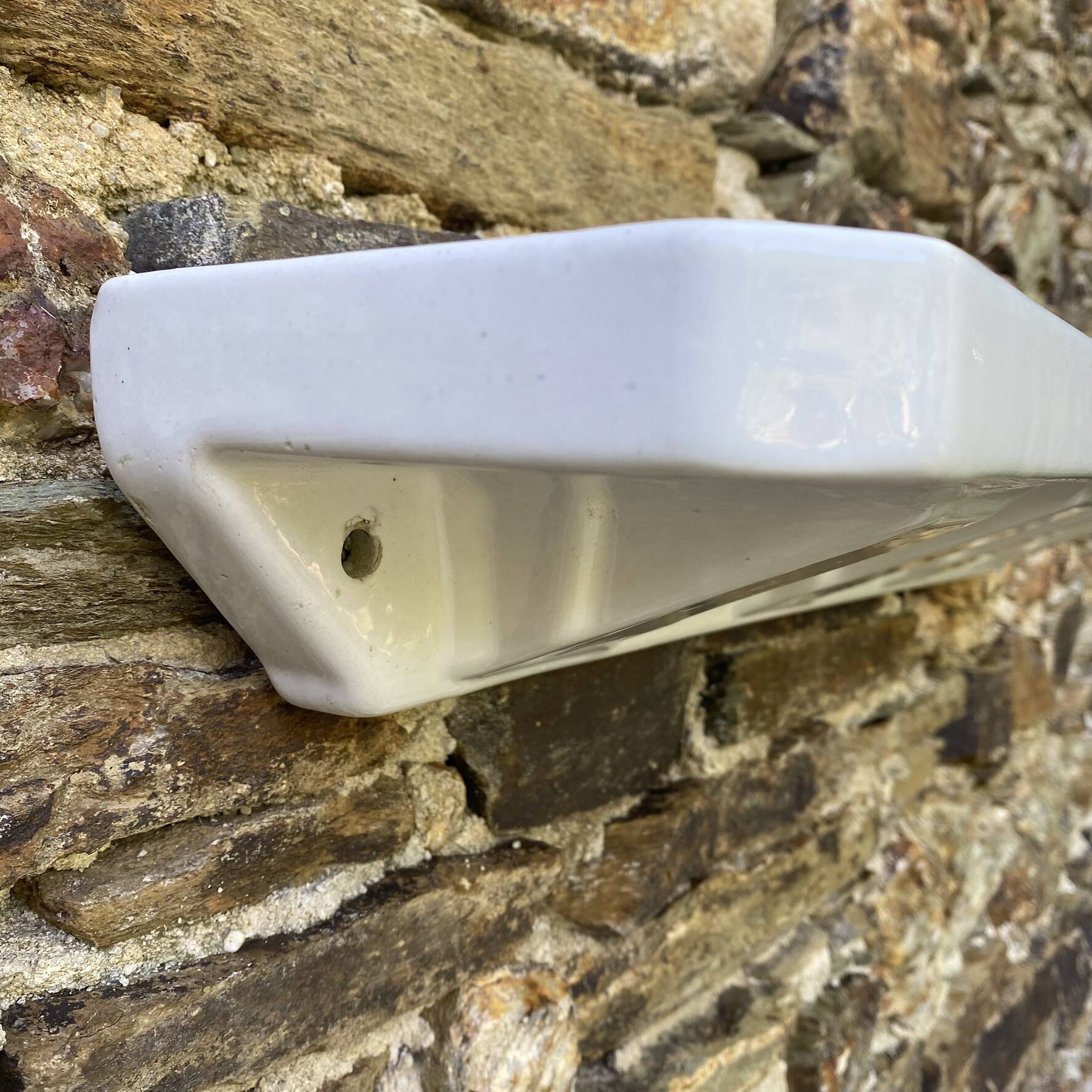 Antique wall shelf for bathroom in white porcelain.