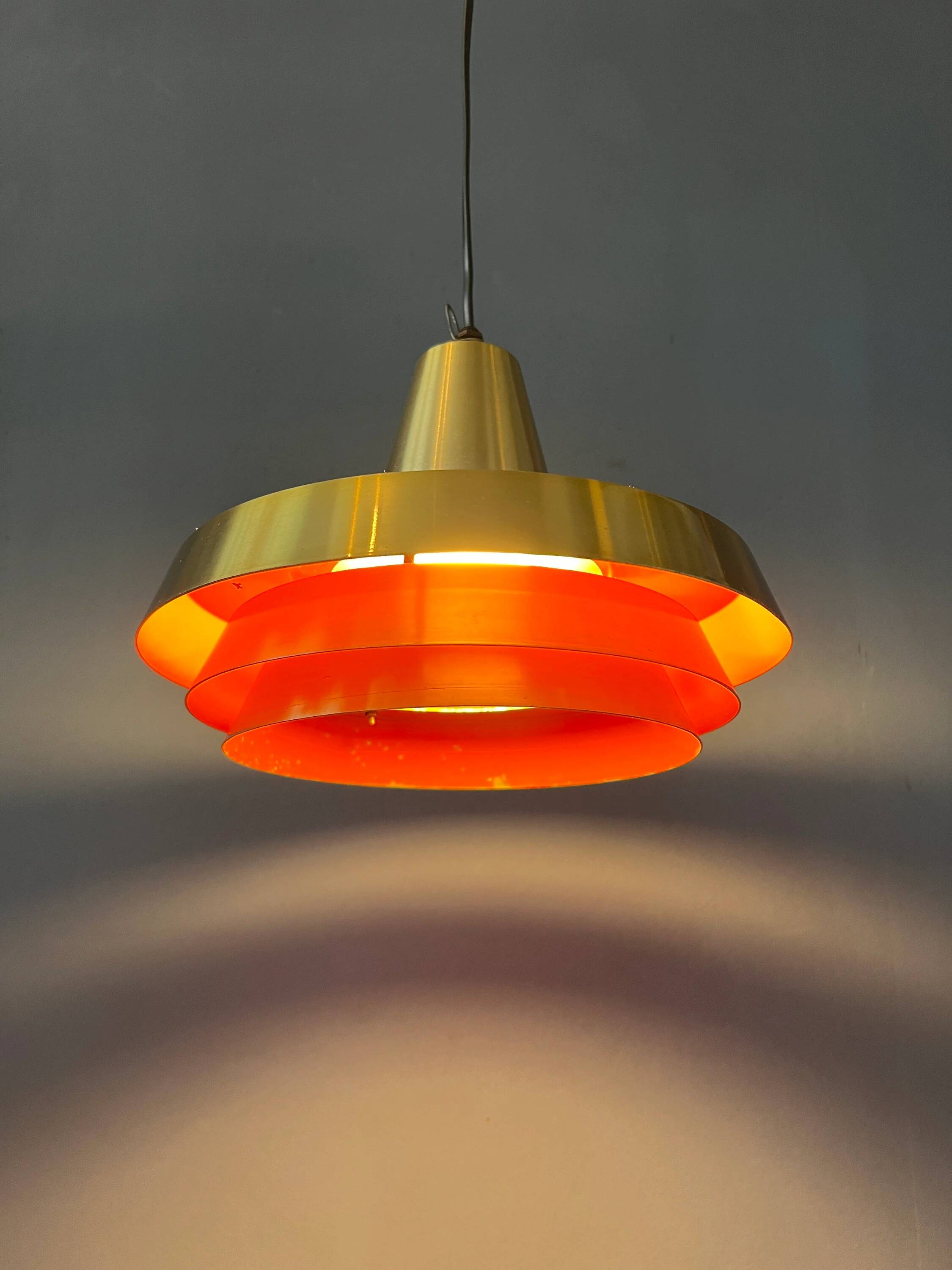 Mid-century Danish style orange brass suspension light.