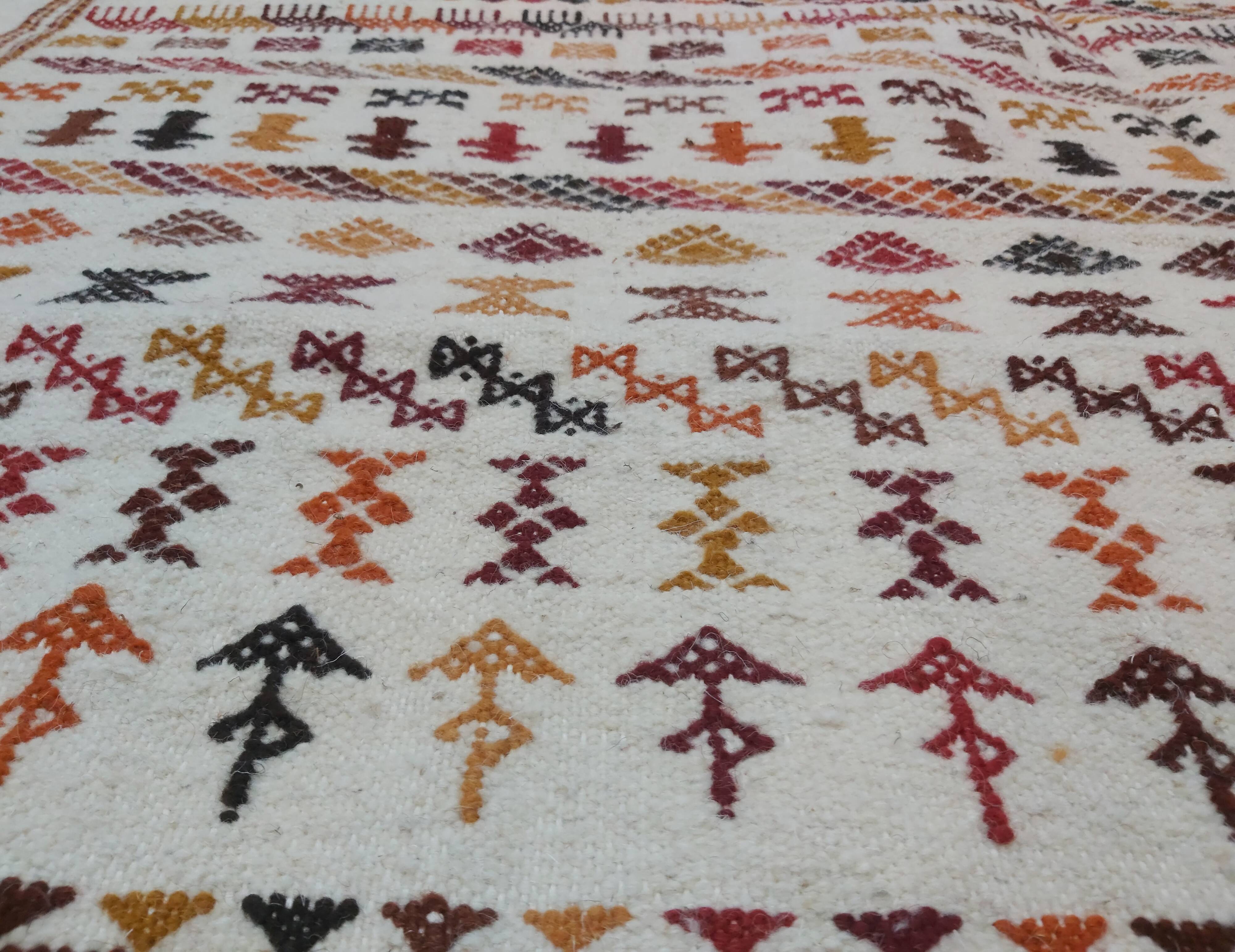 White carpet with multicolored Berber patterns