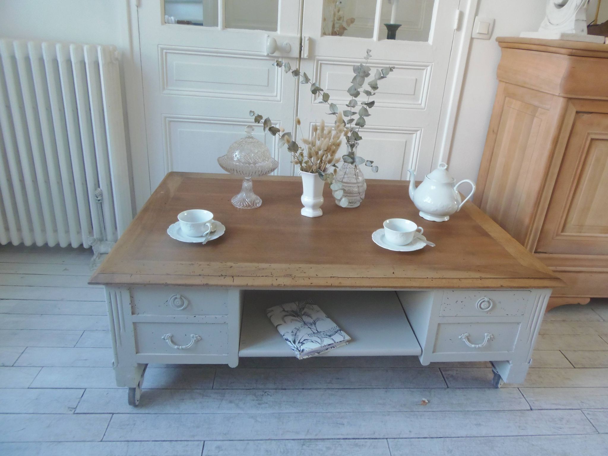 Coffee table on casters, made from an old desk, pearl gray base and belt.
