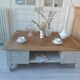 Coffee table on casters, made from an old desk, pearl gray base and belt.