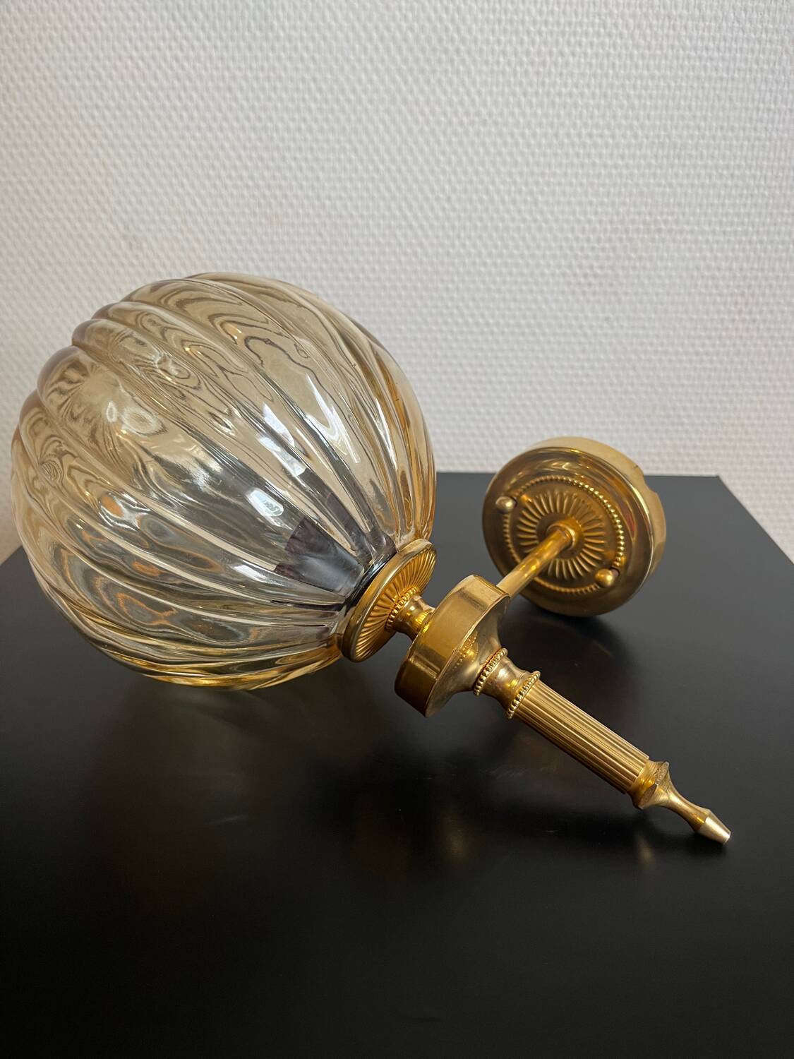 Brass wall light and bubbled glass globe