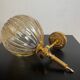 Brass wall light and bubbled glass globe