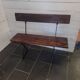 Old garden bench with iron legs and wooden seats