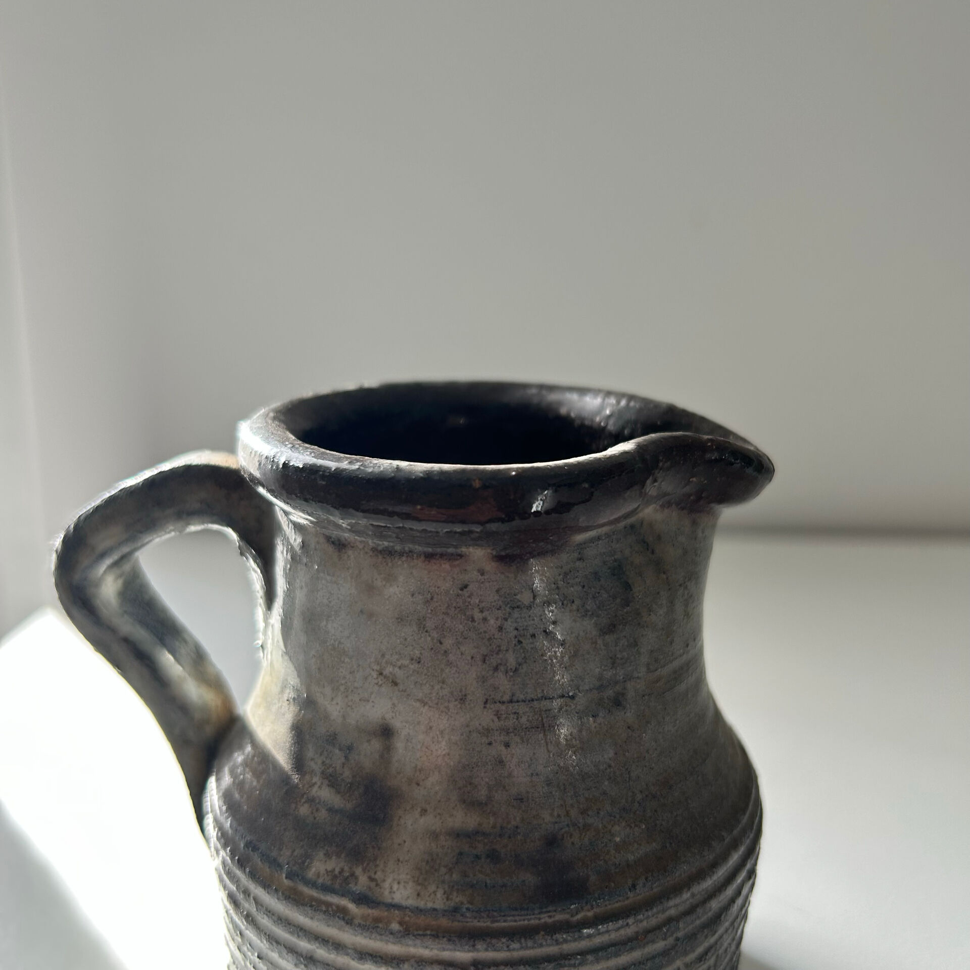 Patinated pitcher signed