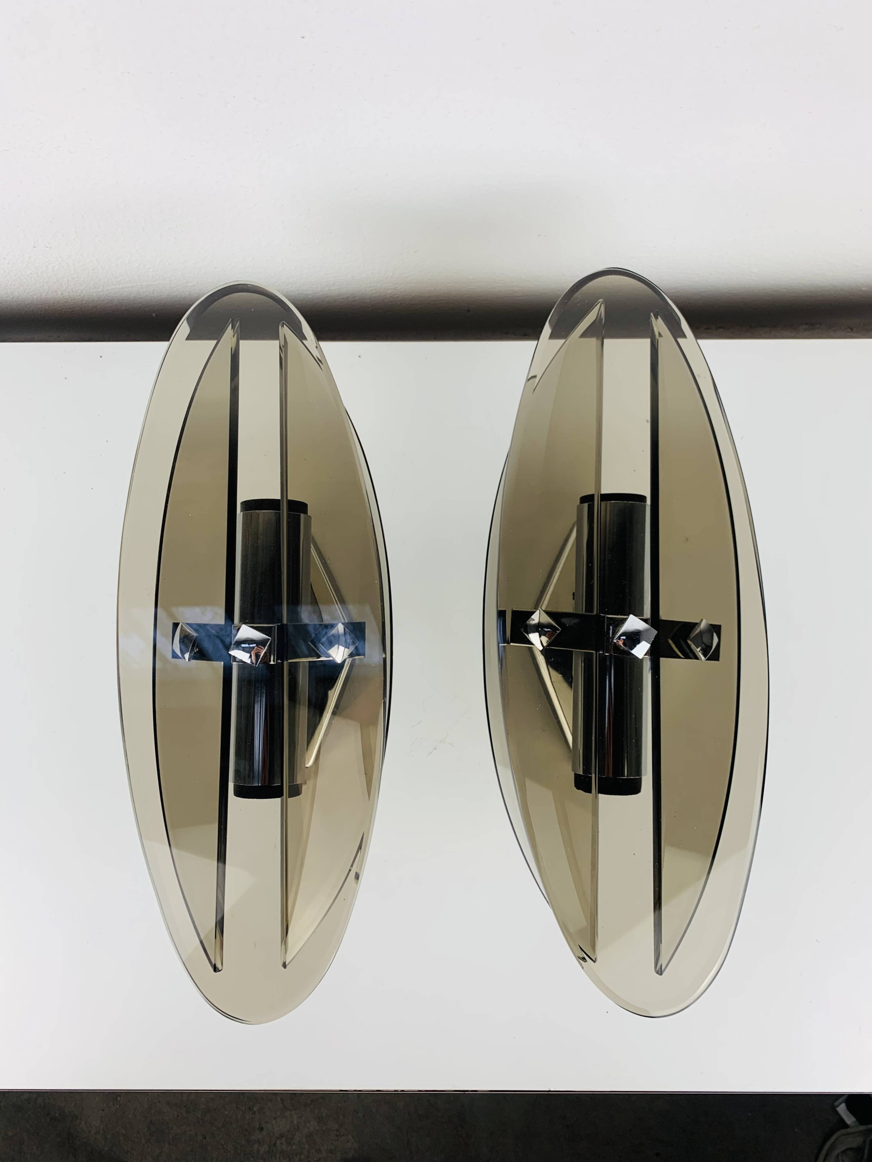 Pair of smoked glass and chrome wall lights from the 1970s.