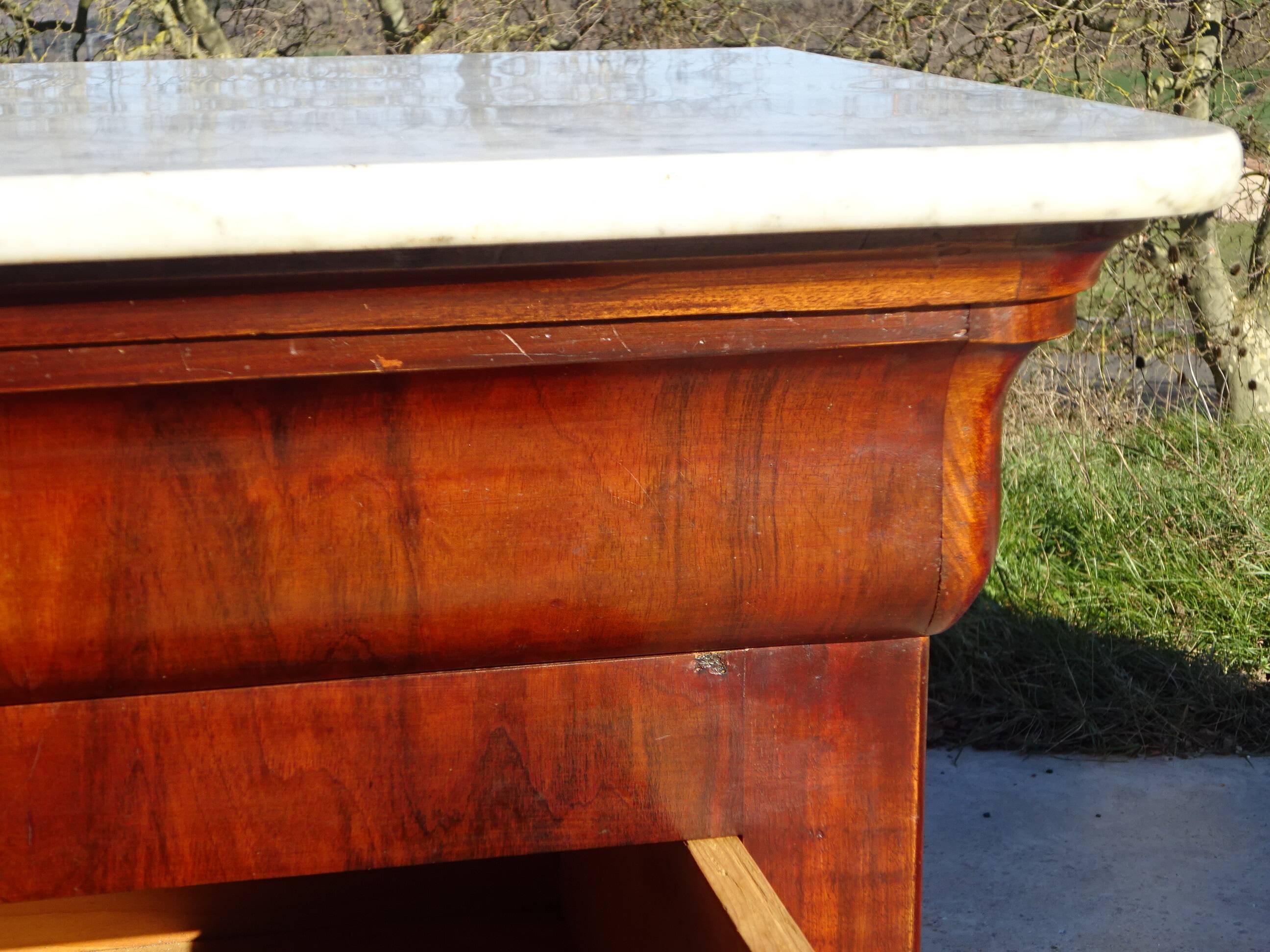 Antique mahogany chest of drawers with white marble.