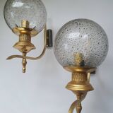 Pair of vintage gold wall sconces with transparent globes