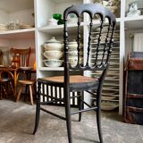 Napoleon III chair in black and gold wood with caning.