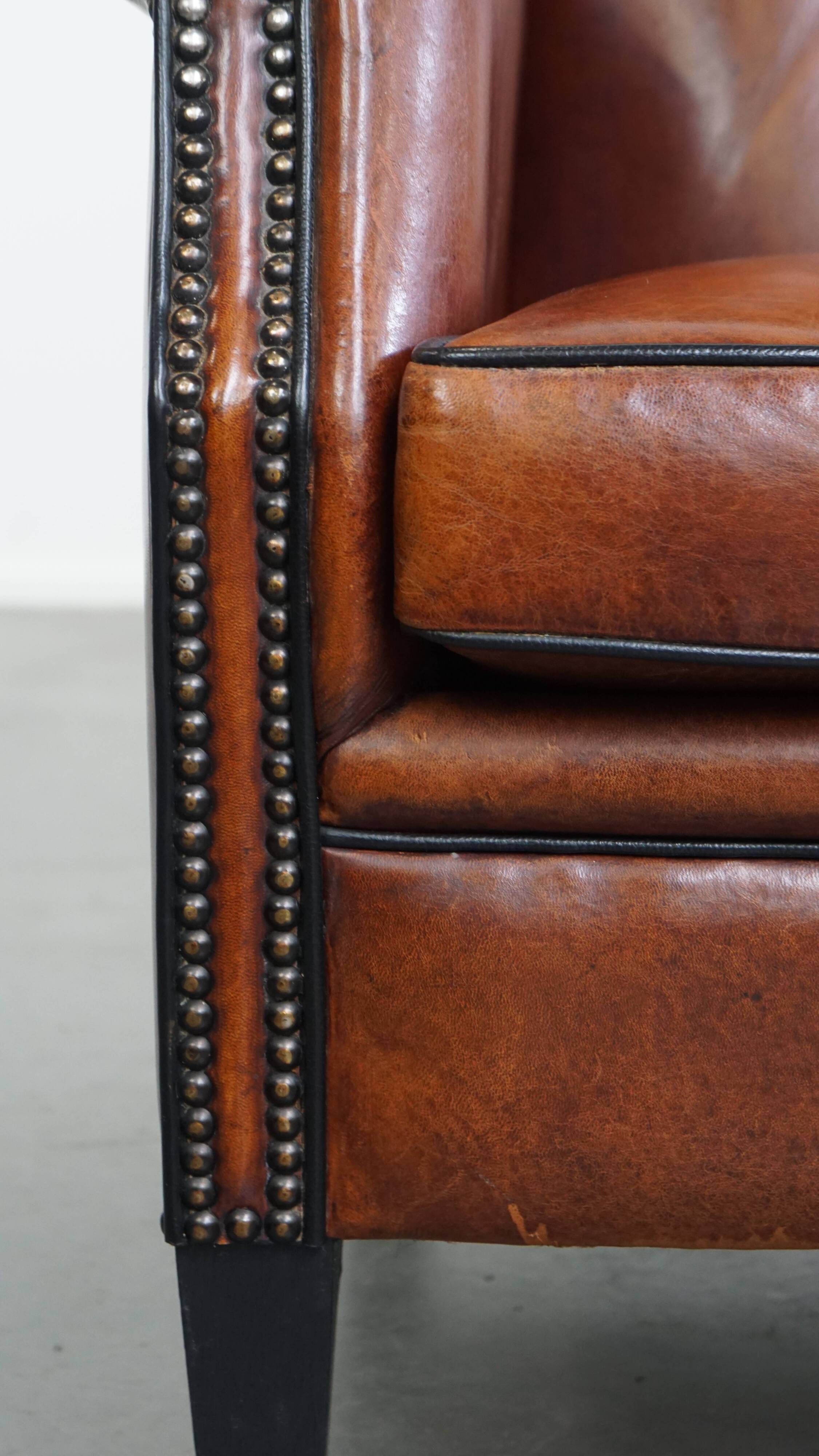 Sheepskin Wingback Chair with Warm Tones and Black Piping