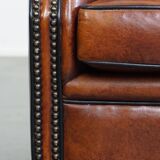 Sheepskin Wingback Chair with Warm Tones and Black Piping