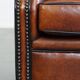 Sheepskin Wingback Chair with Warm Tones and Black Piping