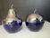 A pair of vintage cobalt glass and silver-plated sugar bowls.
