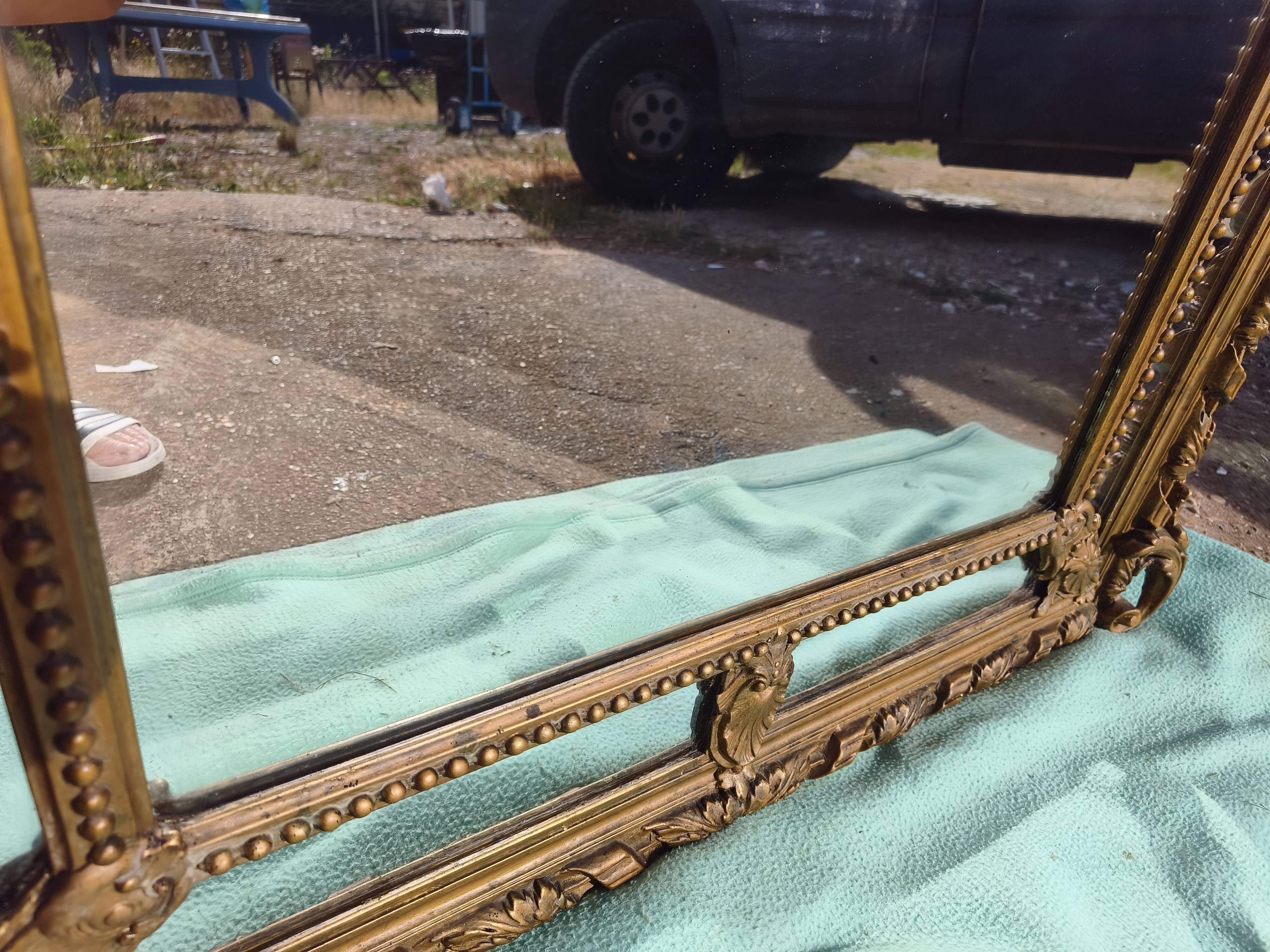 Large closed mirror, 19th century, wood and gilded stucco.