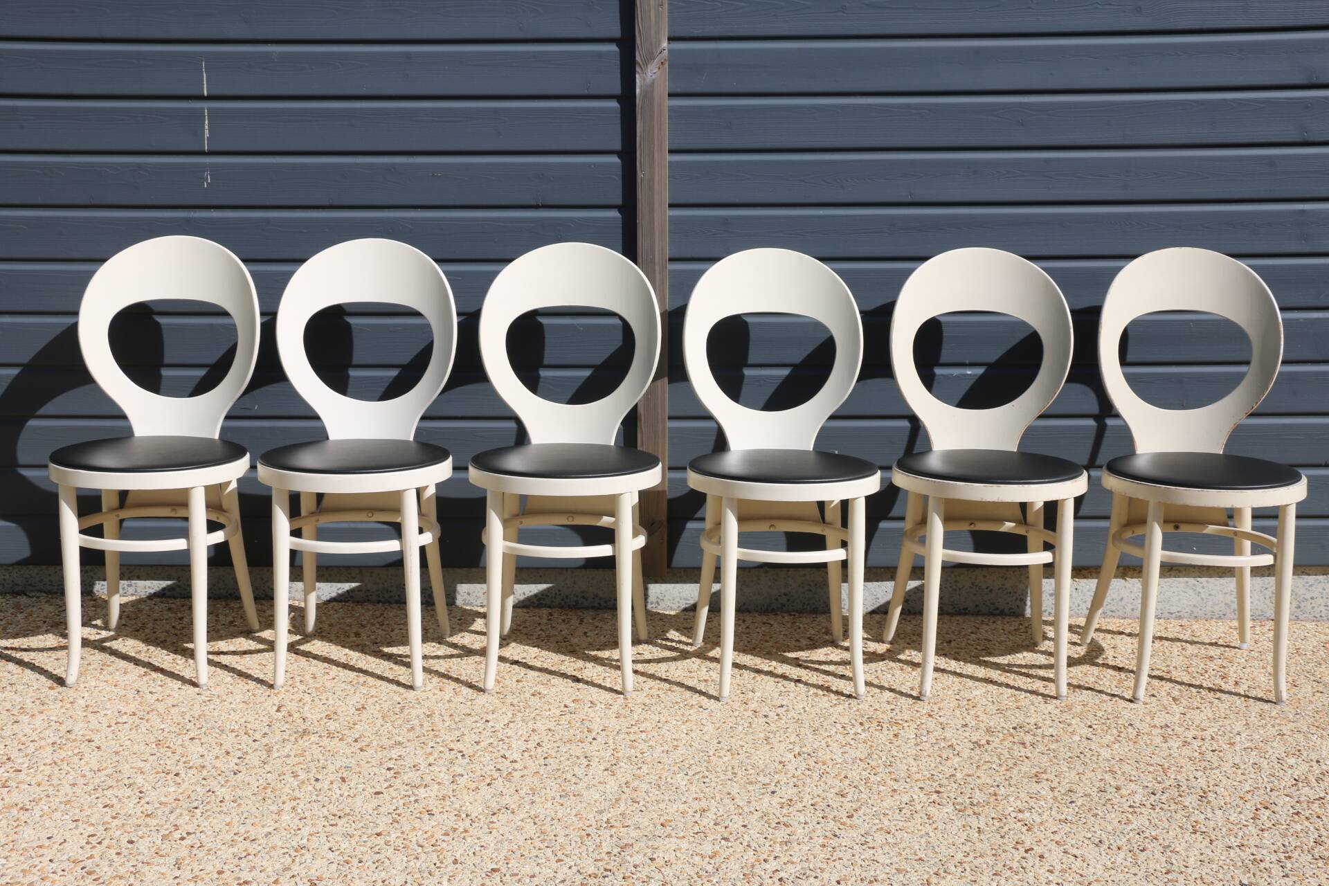 6 baumann chairs, white gull with black faux leather.