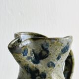 Small handcrafted ceramic pitcher with spotted enamel