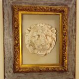 Antique gilded frame with stone lion head ornament on plexiglass