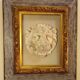 Antique gilded frame with stone lion head ornament on plexiglass