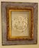 Antique gilded frame with stone lion head ornament on plexiglass