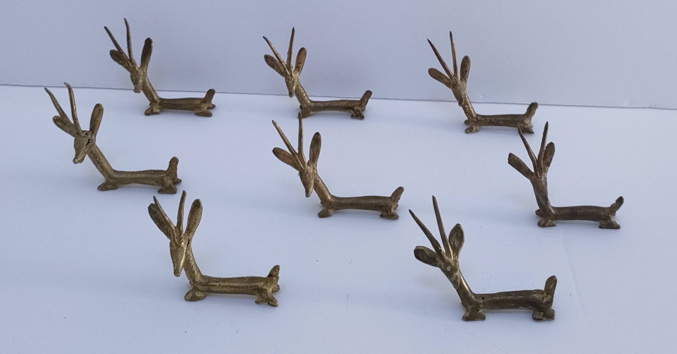eight vintage brass Gazelle knife rests